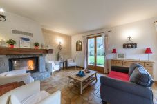 Cosy living room with sofa and armchair ideal for family get-togethers 